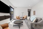 Relax in the modern, luxurious living room with plenty of comfortable seating